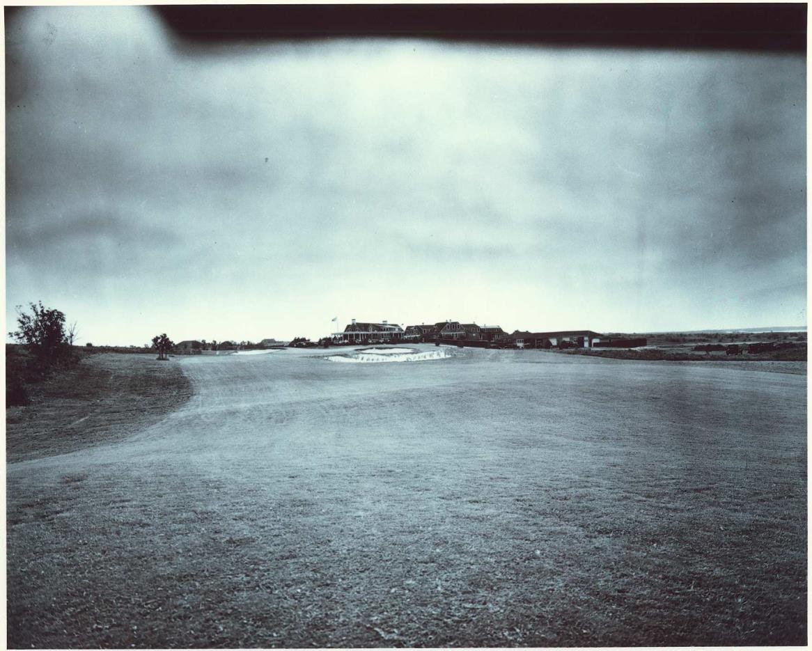 1920s view of the Shinnecock Hills clubhouse from the fairway, with bunkers in the foreground