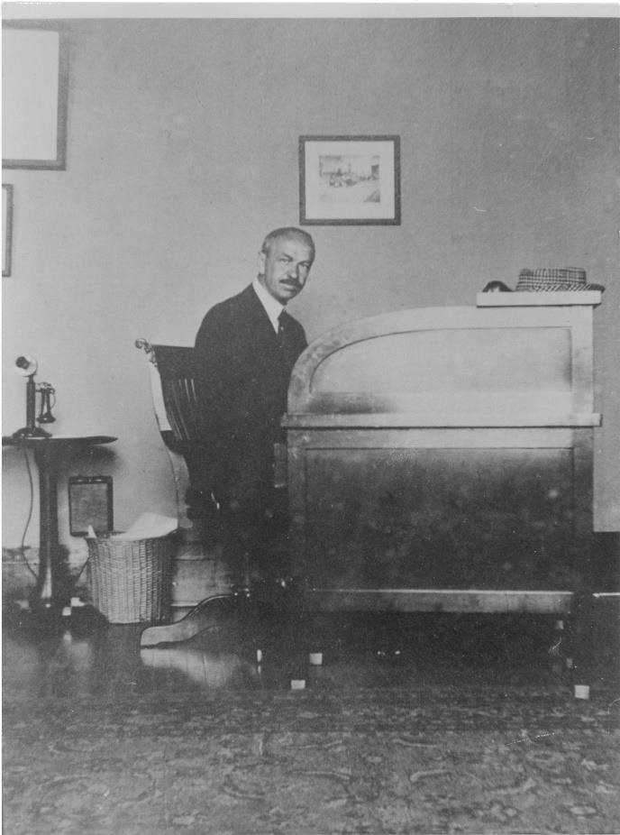 William Flynn working at his desk in an office, circa 1920s
