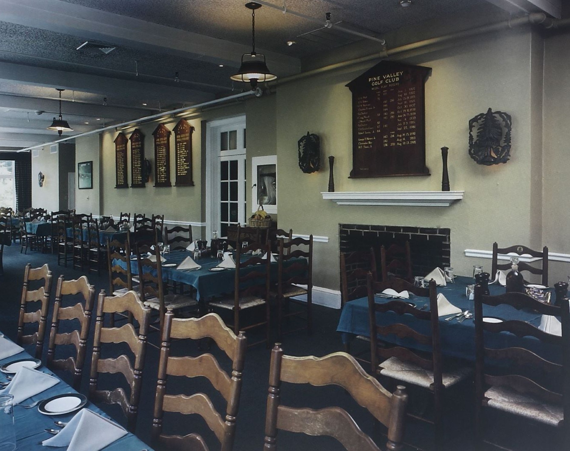 The Pine Valley dining room with championship boards above the fireplace