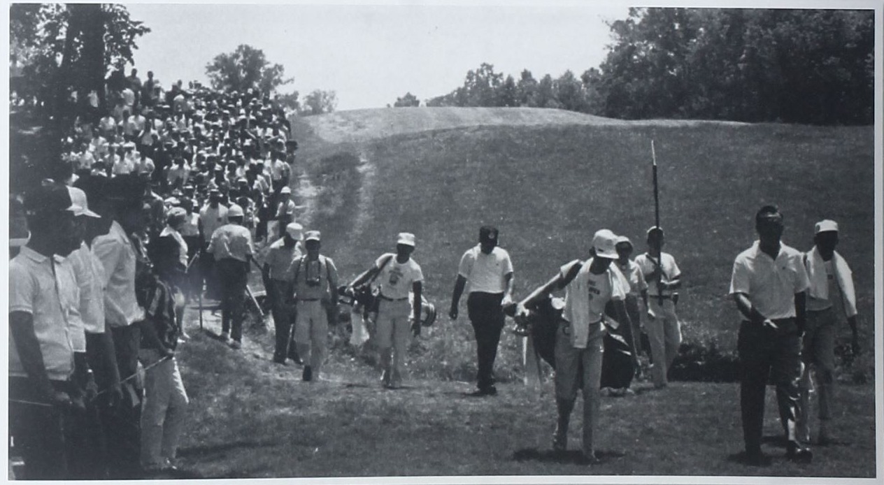 Arnold Palmer walking a Bellerive fairway with caddies during the 1965 U.S. Open